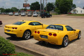 2010 Chevrolet Camaro 2LT and a 2002 supercharged Z06 Corvette, both in Yellow.