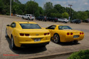 2010 Chevrolet Camaro 2LT and a 2002 supercharged Z06 Corvette, both in Yellow.