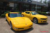 2010 Chevrolet Camaro 2LT and a 2002 supercharged Z06 Corvette, both in Yellow.