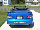 1998 Mustang Cobra Convertible - 1 of 223 - Electric blue, with top down, and stainless COBRA letters.