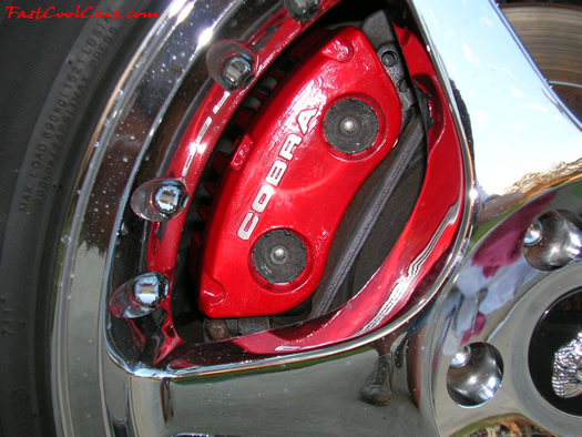 View of painted caliper on 1998 Cobra convertible through the chrome 2000 Cobra wheel.