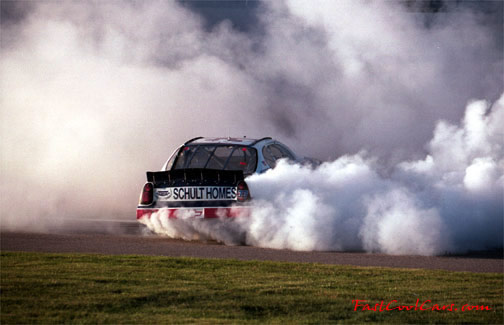 Racecar smoldering the tires in a few victory donuts
