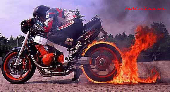 Pretty young lady roasting the tire off this superbike