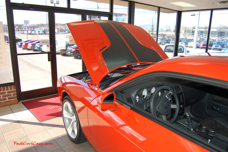2009 Dodge Challenger SRT8 - 6.1 Hemi with 425HP, and this one is a 6 speed the striped kit on the hood looks great, I think they should have went over the whole car with it personally.