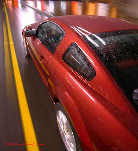 2005 Ford Mustang left rear top view, rolling down the street in the rain