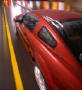 2005 Ford Mustang left rear top view, rolling down the street in the rain