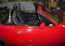 1990 Mazda Miata Roadster - Soft top, 5 speed, little red sports car.