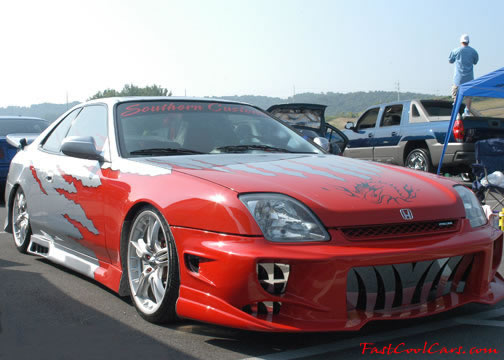 Lowriders that have been lowered, dropped, slammed, and scraping. Very low.