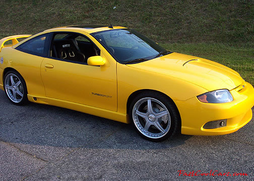 Lowriders that have been lowered, dropped, slammed, and scraping. Sweet yellow paint.