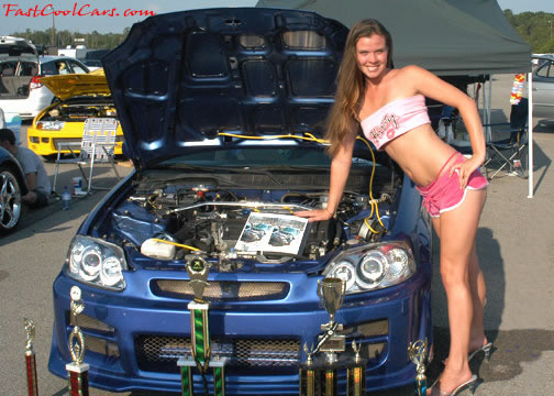 Lowriders that have been lowered, dropped, slammed, and scraping. Sexy young lady.