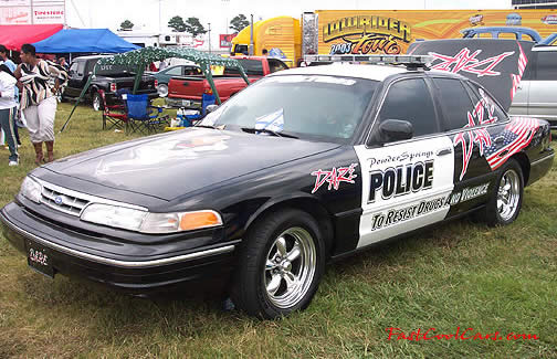 Lowriders that have been lowered, dropped, slammed, and scraping, using many different modifications. police car