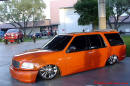 Lowrider Blazer that has been lowered, dropped, slammed, and scraping, using many different modifications.