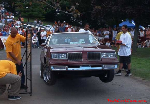 Lowriders that have been lowered, dropped, slammed, and scraping. Hydraulic bouncing height contest.