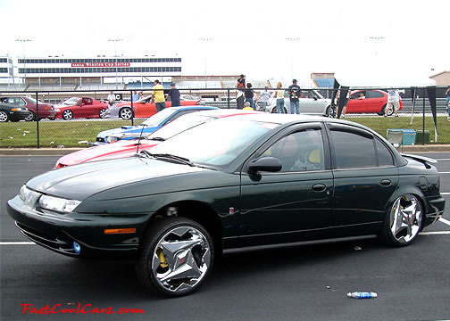 Lowriders that have been lowered, dropped, slammed, and scraping. Big chrome wheels.
