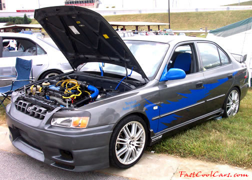 Lowriders that have been lowered, dropped, slammed, and scraping.