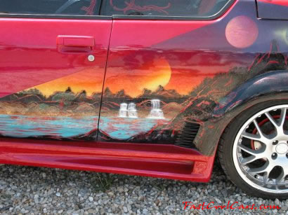 Lowriders that have been lowered, dropped, slammed, and scraping. Nice mural.