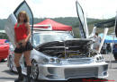 Lowriders that have been lowered, dropped, slammed, and scraping. Pretty young lady.
