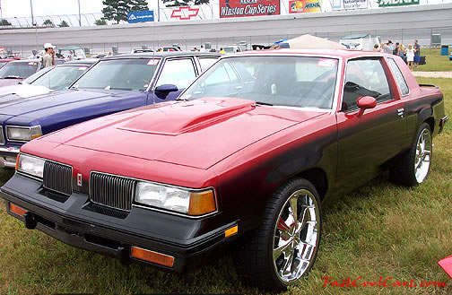 Lowriders that have been lowered, dropped, slammed, and scraping. large chrome wheels.