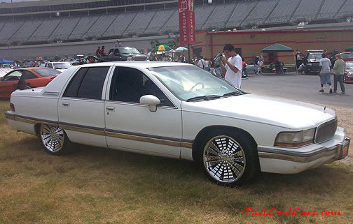 Lowriders that have been lowered, dropped, slammed, and scraping. Huge chrome rims.