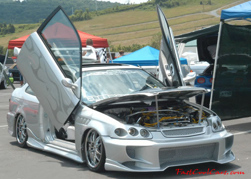 Lowriders that have been lowered, dropped, slammed, and scraping. Love the doors.