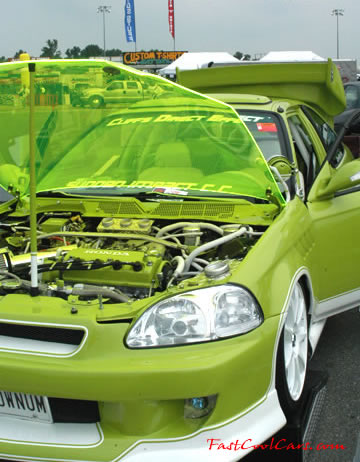 Lowriders that have been lowered, dropped, slammed, and scraping. Check out the see-thru hood, nice!