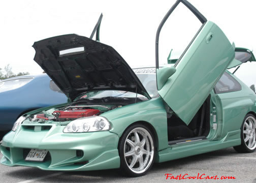 Lowriders that have been lowered, dropped, slammed, and scraping. Gull-winged doors, cool.