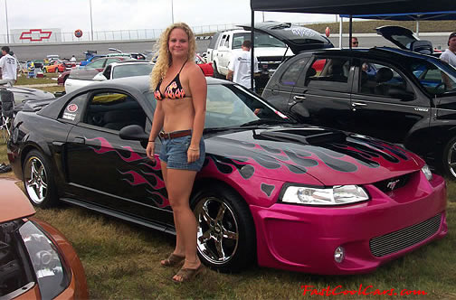 Lowriders that have been lowered, dropped, slammed, and scraping. Killer flame paint job, and sexy woman.