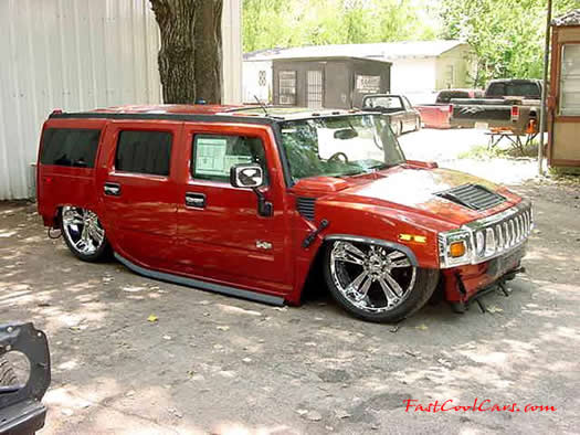 Lowriders that have been lowered, dropped, slammed, and scraping. On the ground Hummer.