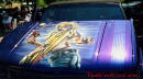 Lowriders that have been lowered, dropped, slammed, and scraping. Mural on cool truck.