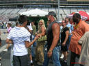 Hulk Hogan stopping a moment to talk to a guy while on there way to the stage for announcements, with his wife Linda, and their son Nick.