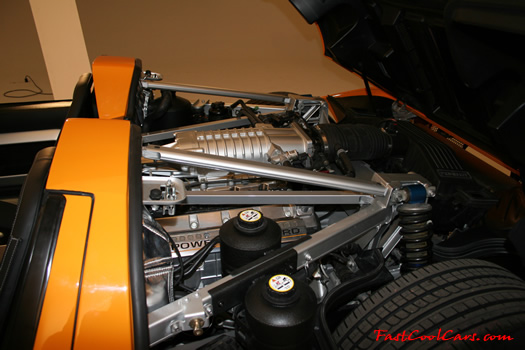 The 2005 Ford GTX1 - Gleaming orange paint with tungsten racing stripes. A removable hard-top aluminum roof. Custom designed forged modular wheels. And a 618-700 horsepower, 5.4L supercharged V-8 engine. 