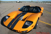 The 2005 Ford GTX1 - Gleaming orange paint with tungsten racing stripes. A removable hard-top aluminum roof. Custom designed forged modular wheels. And a 618-700 horsepower, 5.4L supercharged V-8 engine. 
