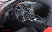2009 Dodge Viper ACR - You're looking at Dodge's answer to the Porsche 911 GT3 RS or Lotus Exige, a road car you can drive to the track, hot lap all day, and drive back home, tires, brakes, and ego intact. The Viper ACR is raw. It's wired. And it's probably the best weekend racer yet from Detroit.