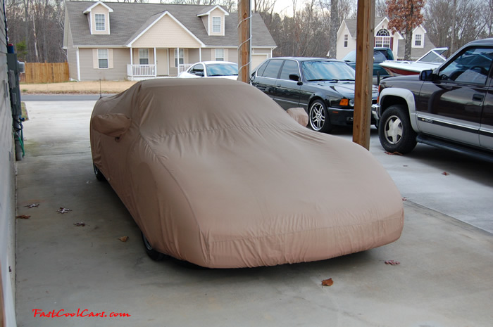 2002 Millennium Yellow Z06 Corvette - 405 HP Stock, resting under the carport wnder its car cover.