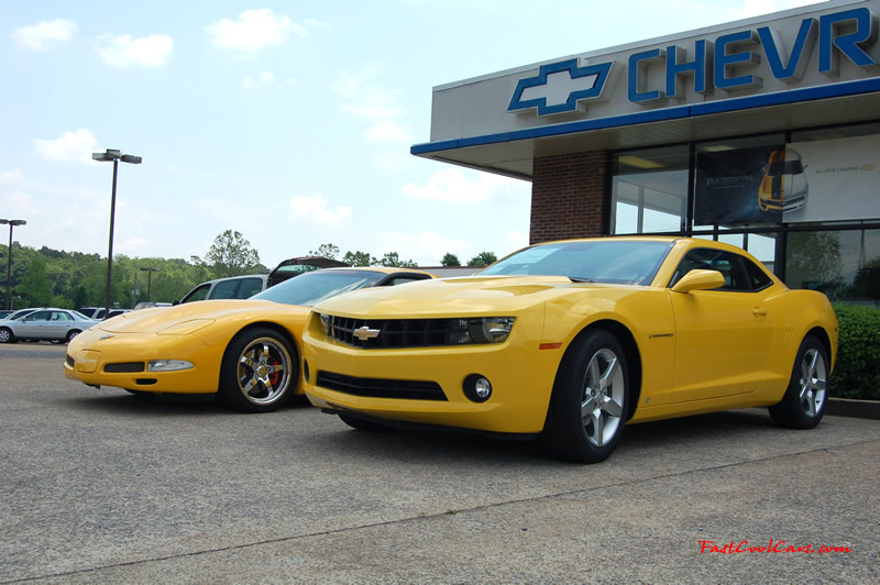 2010 Chevrolet Camaro 2LT and 2002 Supercharged Z06 Corvette, both in yellow.