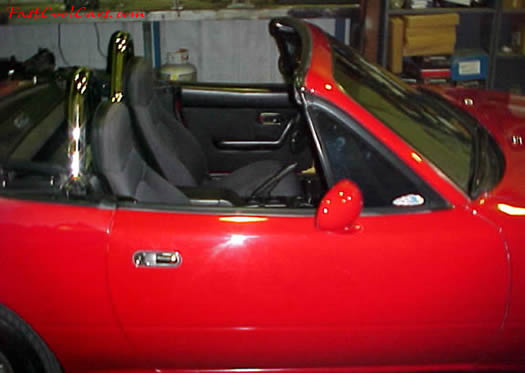 1990 Mazda Miata Roadster - Soft top, 5 speed, little red sports car.