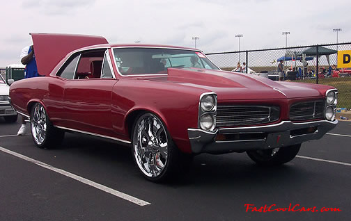 Lowriders that have been lowered, dropped, slammed, and scraping. Hugh chrome wheels.