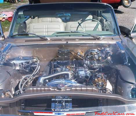 Lowriders that have been lowered, dropped, slammed, and scraping. Classic American low rider, with tri-power, and see-thru hood.