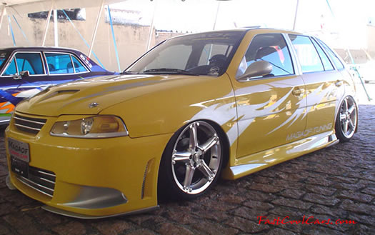 Lowriders that have been lowered, dropped, slammed, and scraping. Yellow paint.