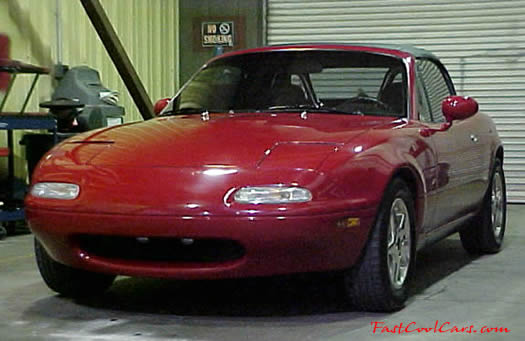 1990 Mazda Miata Roadster left front low angle view with the top up
