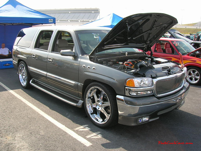 Nopi Nationals - Motorsports Supershow 2005, SUV slammed and riding on big chrome wheels, lowrider.